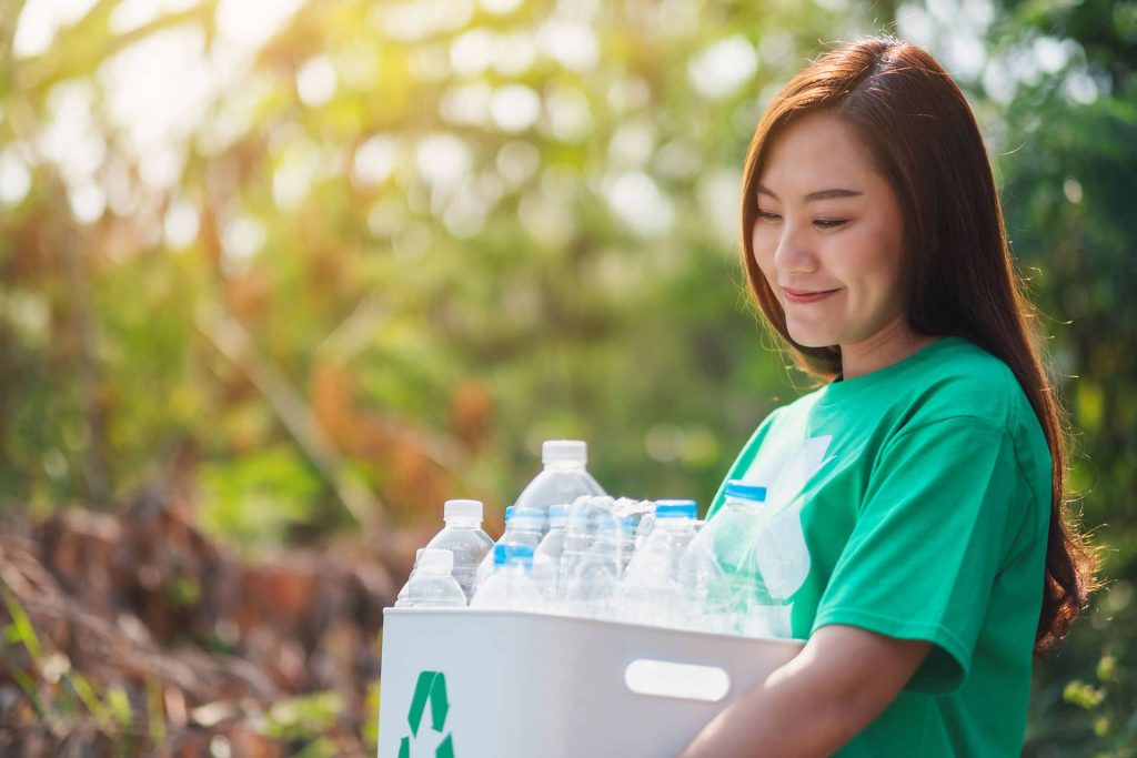 Woman recycling plastic bottles